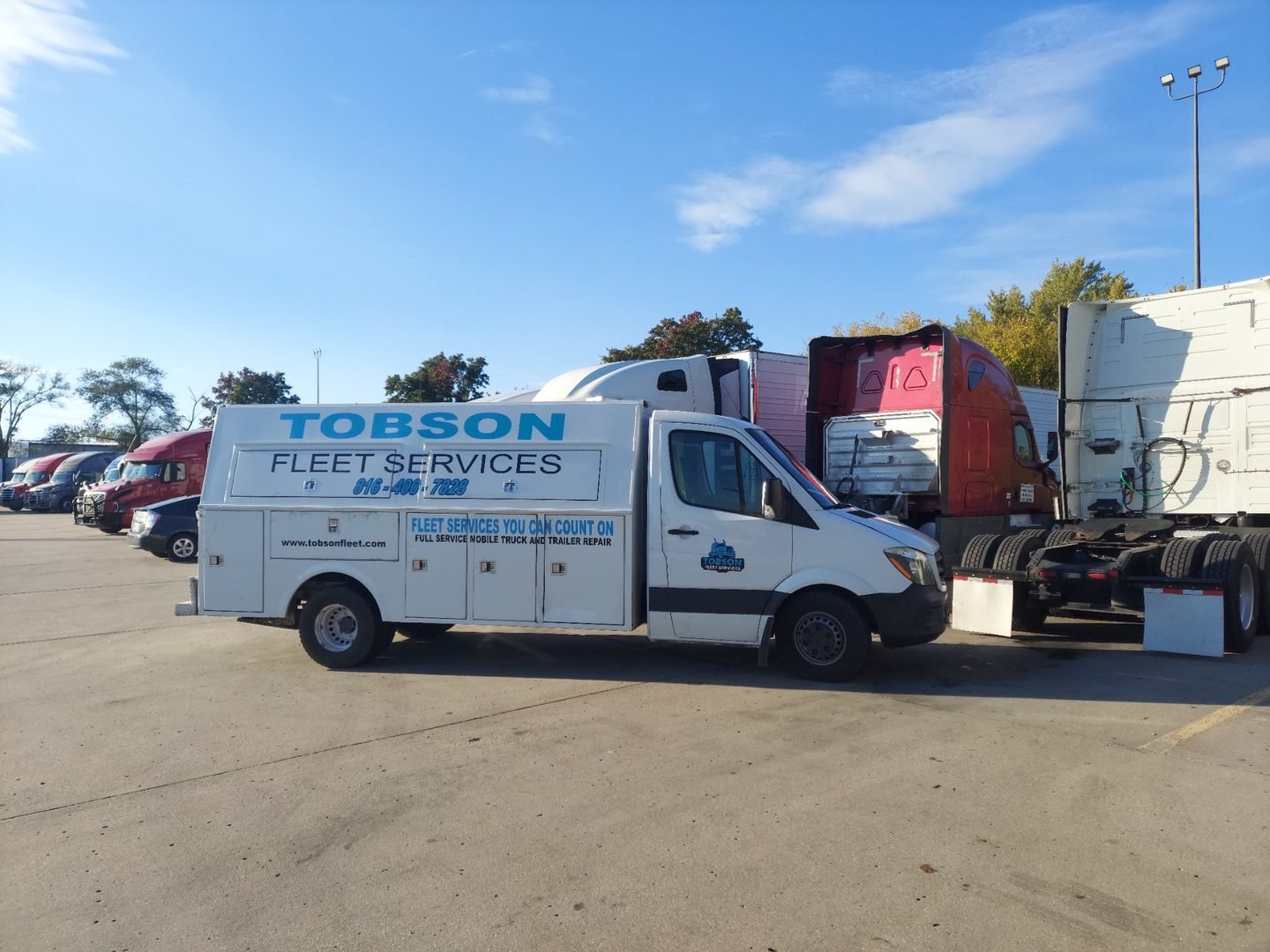 Tobson Fleet Services mobile repair truck parked next to semi trucks at a Kansas City truck lot